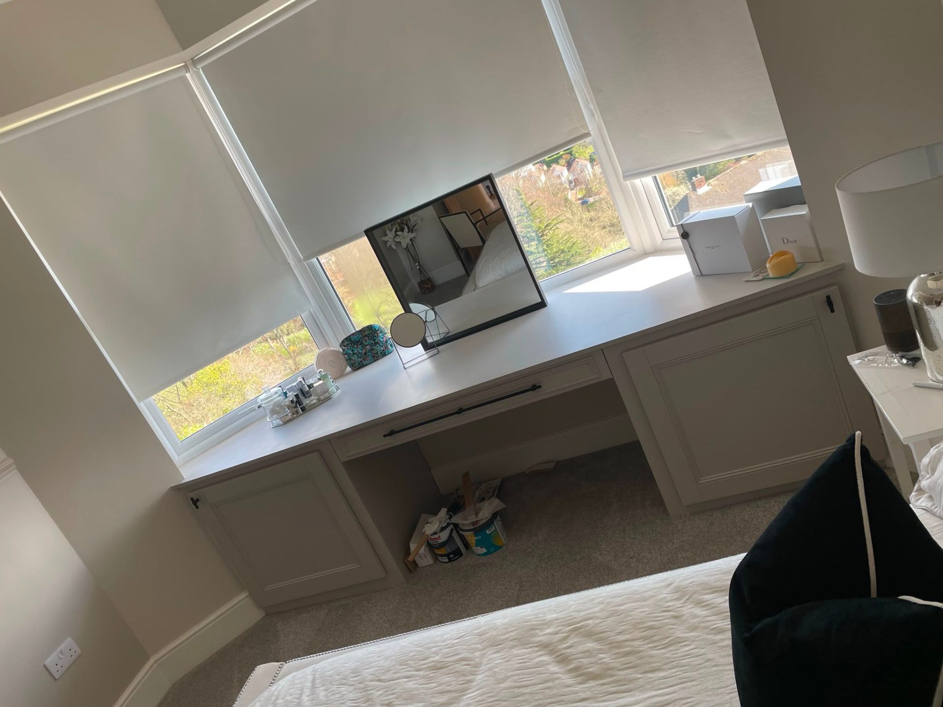 Built-in bespoke dressing table with drawers under a window
